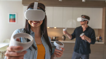 Young cheerful couple guy and girl while playing in virtual reality goggles